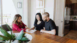 Real estate agent helping young couple understand the market