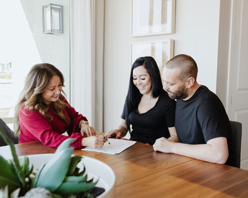 Realtor helping family sign papers for a new home