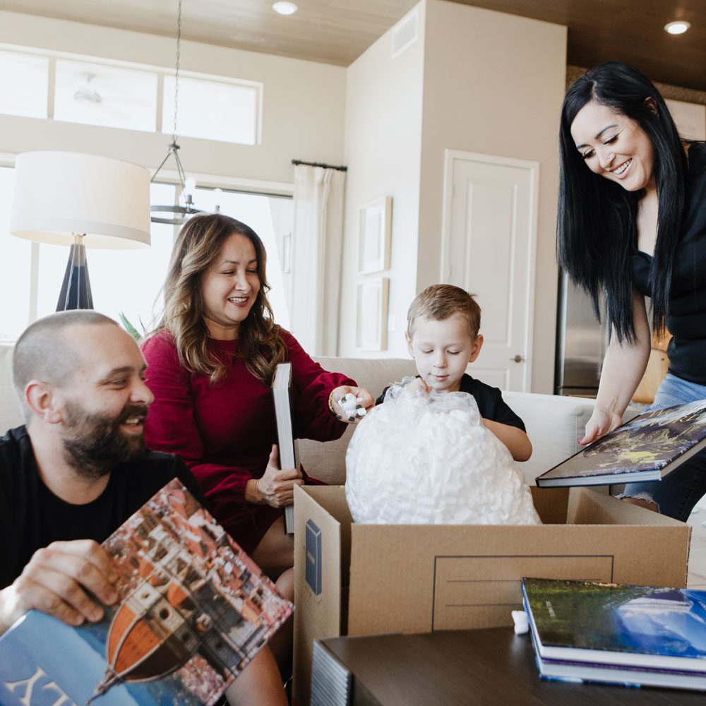 Happy family packing after selling their home