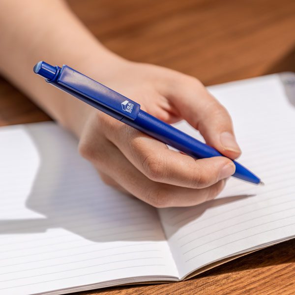 Blue ERA pen writing on notebook